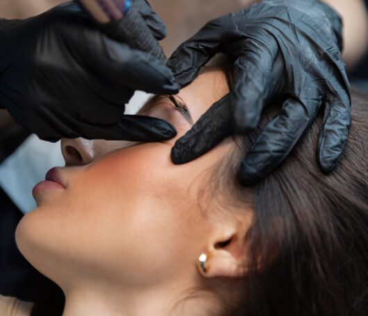 young-woman-getting-beauty-treatment-her-eyebrows